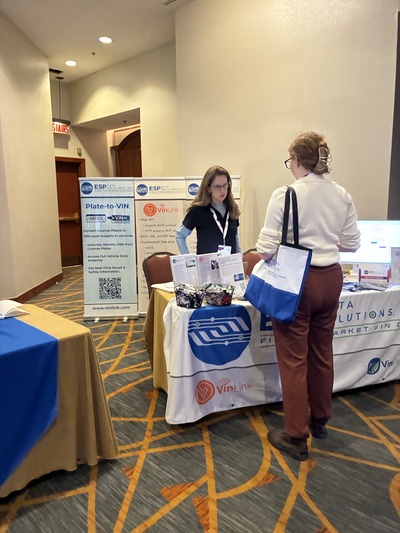 ESP Data Solutions team member discussing VIN data with an insurance technology conference attendee